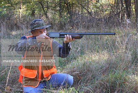 Man hunting in a field in fall