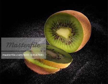 Jucy green kiwi on black velvet