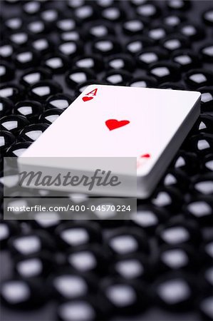 Pack of cards laying on black beads