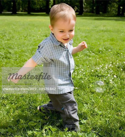 The Kid Running On A Green Meadow