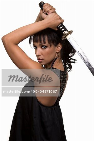 Portrait of an attractive brunette woman wearing black holding samurai sword over head with serious expression over white