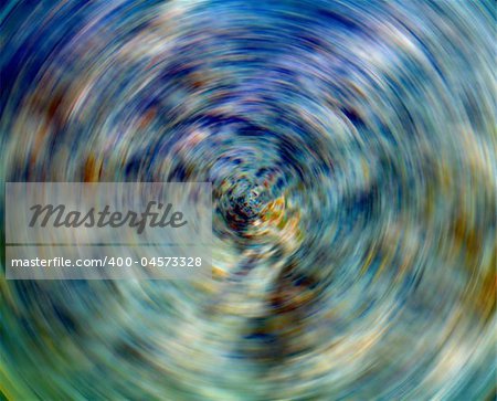 An abstract image of spinning blue and green colors.