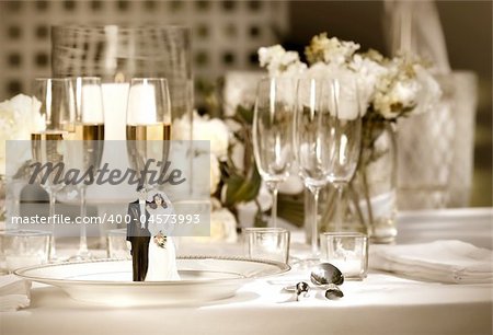 Cake figurines on dinner plate  at wedding reception/ Sepia tone