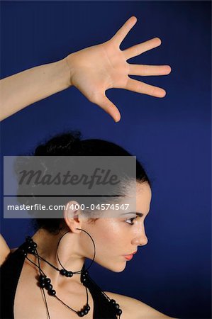 Portrait of young hispanic female model with open hand