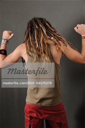 Back portrait of young funky male with long dreadlocks