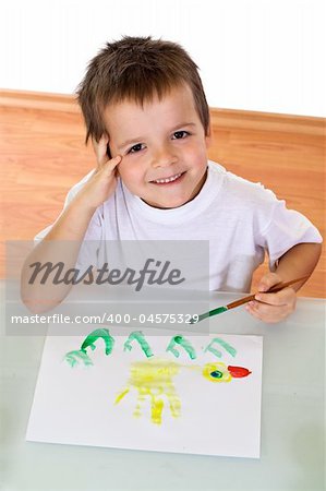 Top view of boy painting with watercolors - isolated