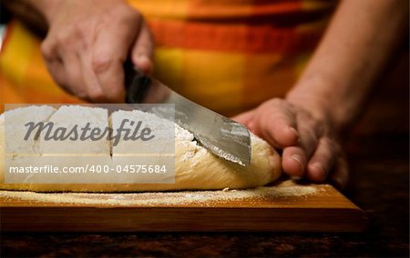 Adding cut to unbaked bread dough with serrated knife