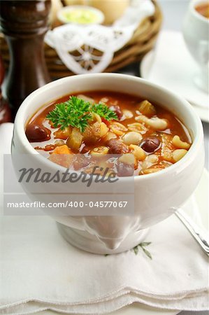 Delicious minestrone soup with fresh baked bread rolls and butter.