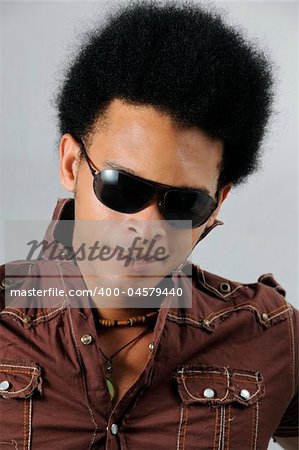 Portrait of young handsome african male model posing with sunglasses