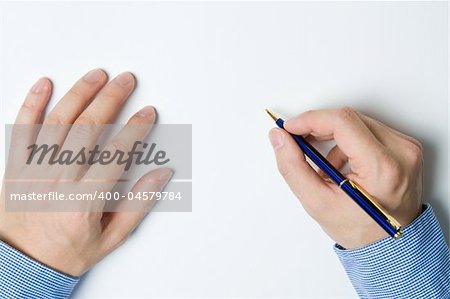 Person writing a message on a piece of paper or note