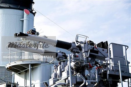 Large white guns on a military naval vessel