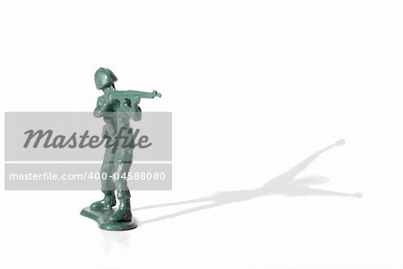 A toy soldier in battle with his shadow surrendering.