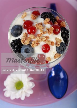 Three yogurt in the glass with fruits and cereal