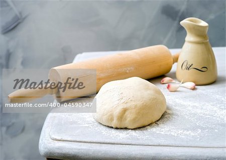 dough, rolling-pin, olive oil and garlic