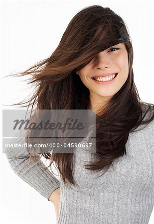 Beautiful young eurasian woman smiling with wind in the hair