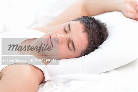Man sleeping on white bed