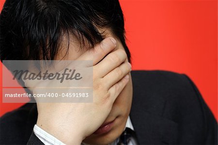 A stressed out businessman having a headache