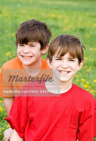Two Smiling Brothers in Bright Orange and Red Shirts