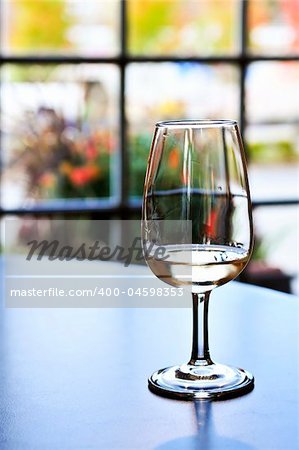 White wine glass in winery tasting event