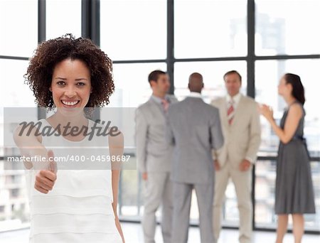 Smiling business woman showing team spirit on from of Business Team