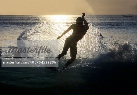 Young men - the surfer in ocean. Bali. Indonesia