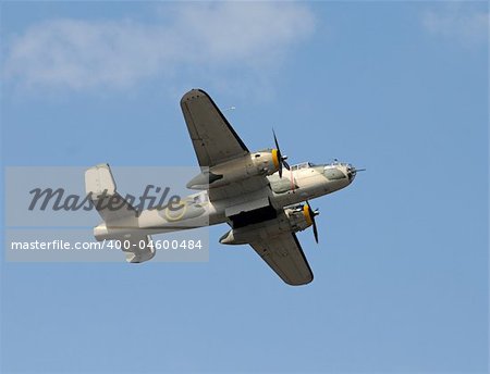 World War II era bomber flying overhead