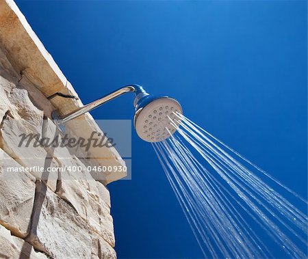 Cold Shower in the Hot Summer Day and Blue Sky in the Background