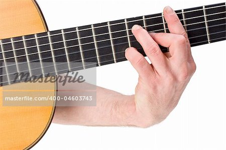 male hand holding a chord on a classsical guitar