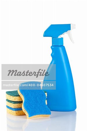Plastic detergent spray bottle and sponges reflected on white background