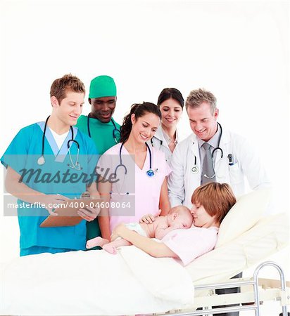 Group of doctors with a mother and her newborn baby