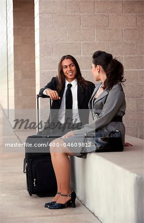 Handsome man and pretty woman at airport or station