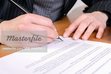 Close-up of business woman signing a contract