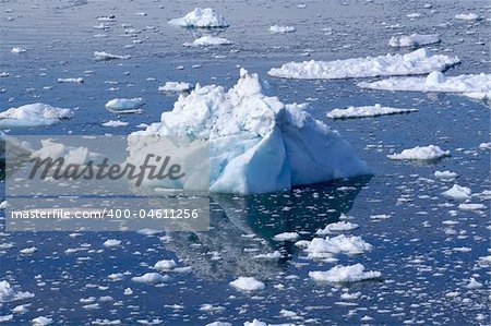 A small white/blue iceberg lying in the water in Ilulissat, Greenland