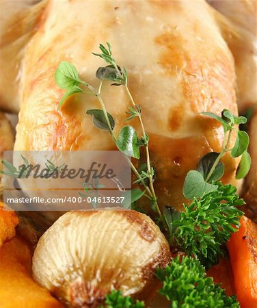 Whole roast chicken with potatoes pumpkin and carrots.