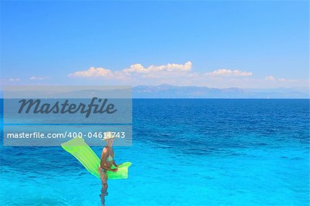 Beautiful young woman enjoying the Ionian sea in Greece