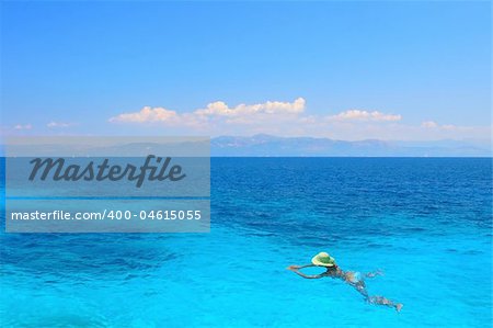 Beautiful young woman enjoying the Ionian sea in Greece