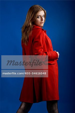 Portrait of a beautiful and sexy young model posing with a red jacket