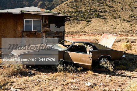 Abandoned Junk Car in Desert next to House