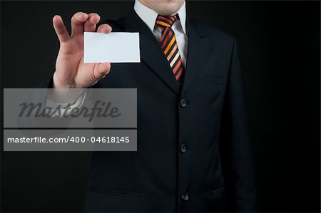 businessman holding blank card