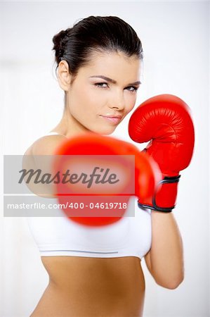 Young beautiful woman during fitness time and boxing