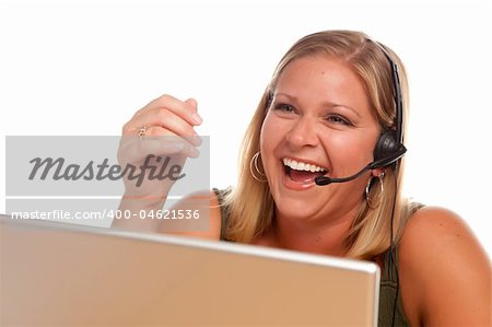 Attractive businesswoman Laughs as she talks on her phone headset.