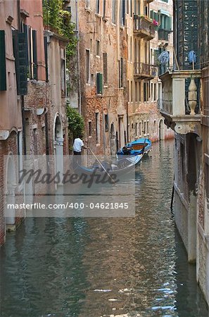 view down a water canal in Venice, Italy with a Gondola