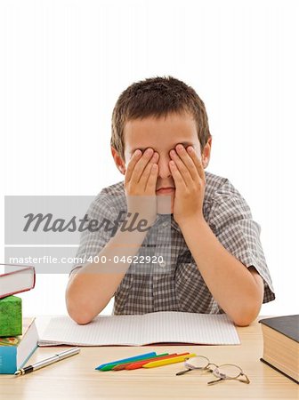 Tired schoolboy covering his eyes - isolated