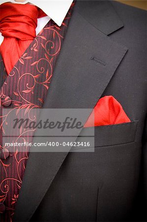 suit jacket of groom and red cravat ascot tie