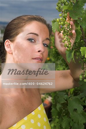 Young attractive Woman with grapes in her hand