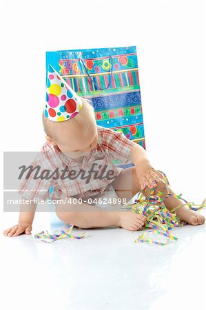 Child boy in birthday hat over white