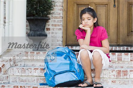 Girl with Backpack Sitting on Steps