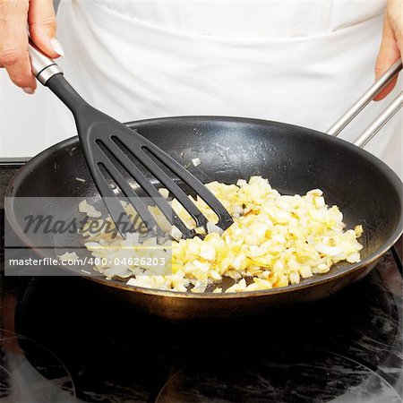 Chef frying onion