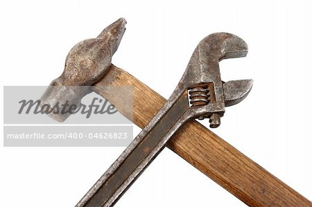 Hammer and spanner. Old and dirty condition. Under construction symbol. Isolated on white.