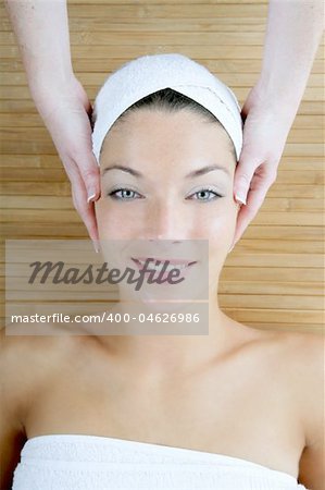 Head massage over bamboo, beautiful blue eyes woman